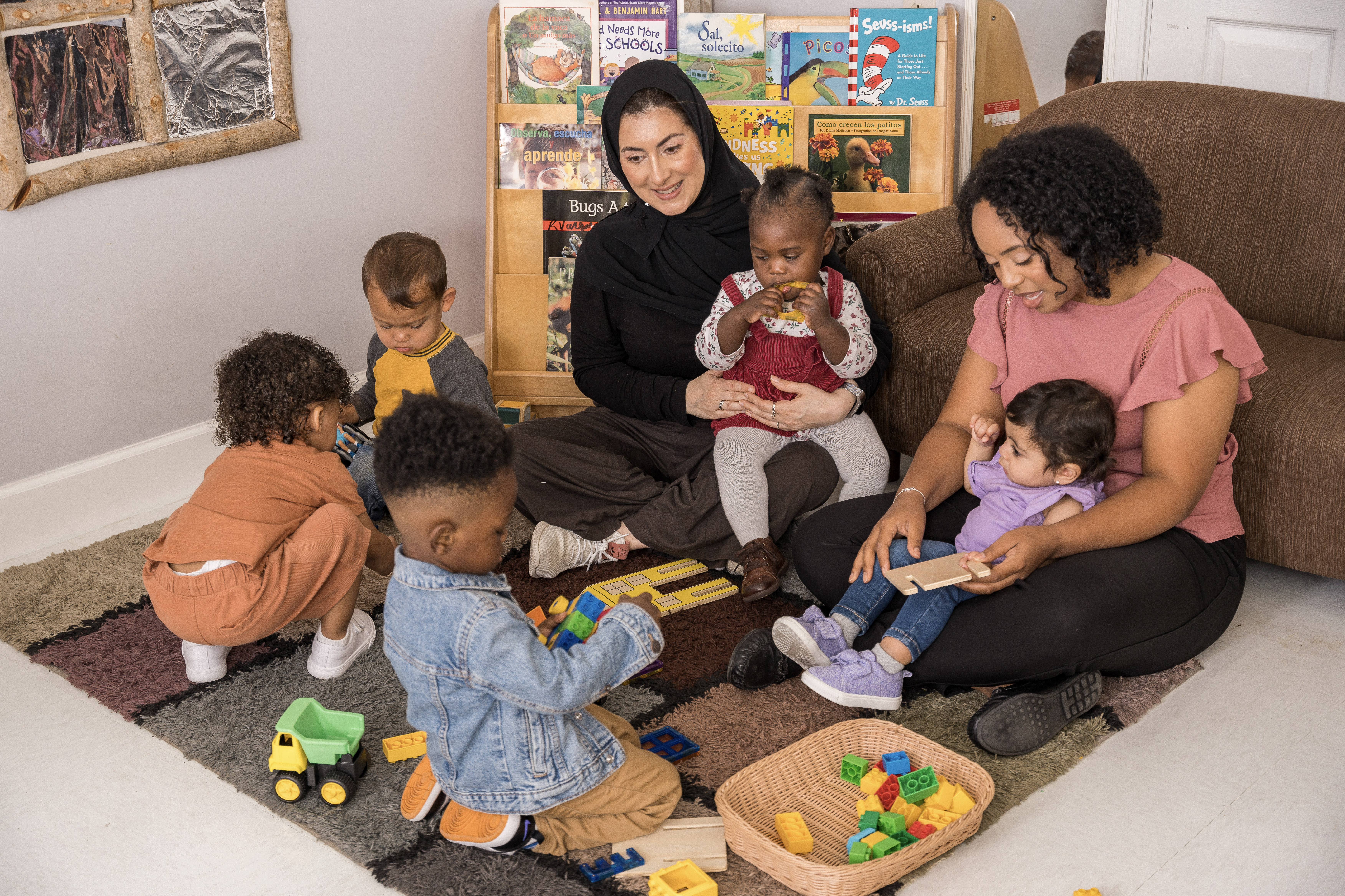 Teachers and children playing with toys