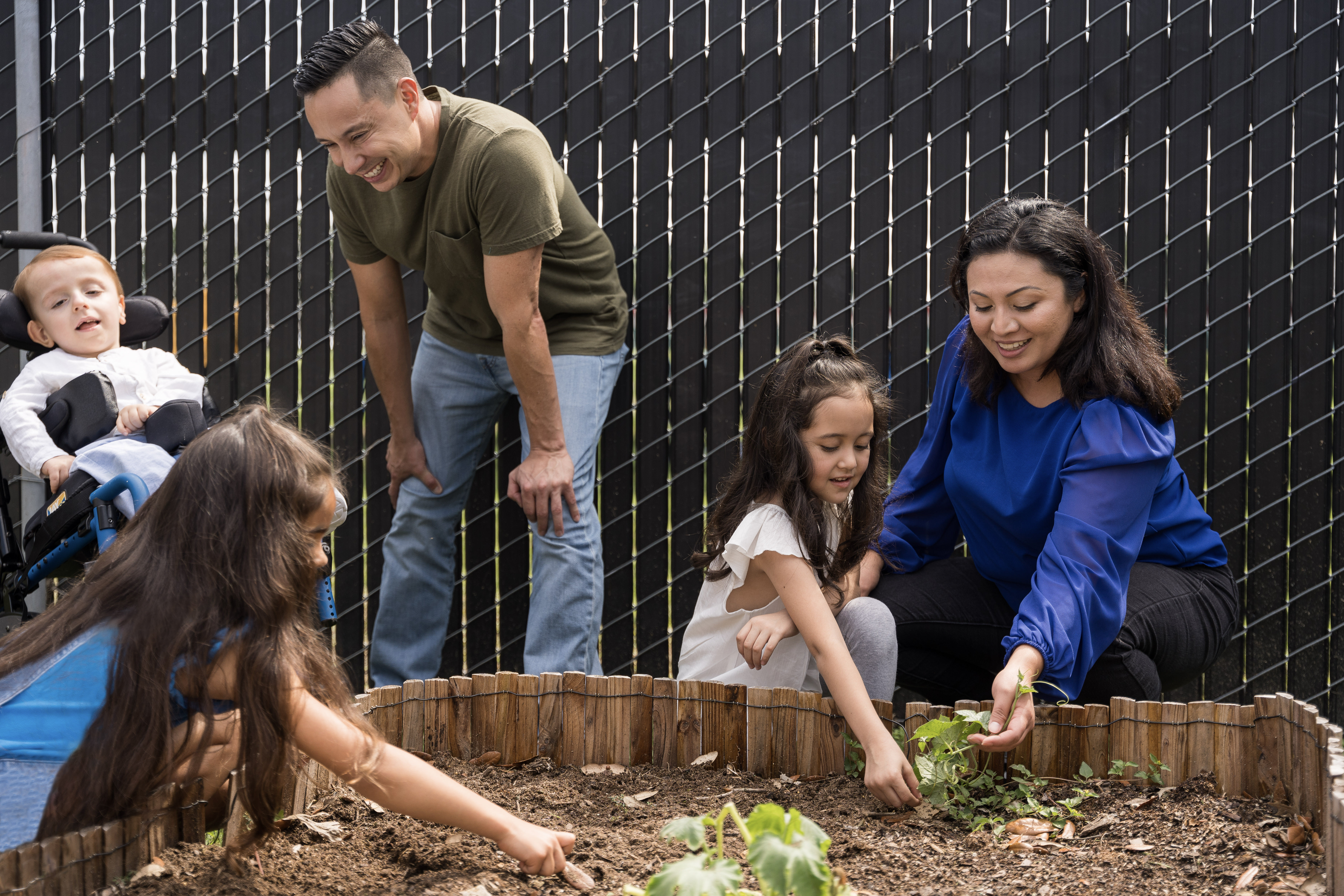 Teachers and children playing with plants
